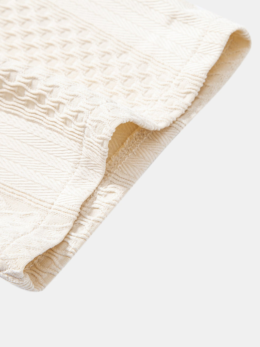Camisa abotonada de jacquard geométrico y pantalones rectos con textura arrugada.
